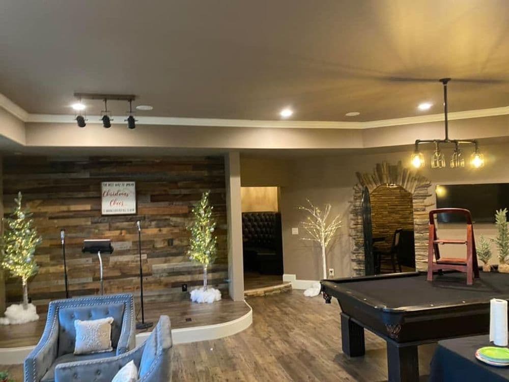 Cozy event space featuring rustic decor, pool table, and elegant lighting.