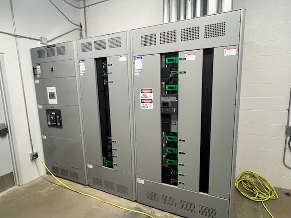 Electrical distribution panels with circuit breakers in an industrial facility setting.