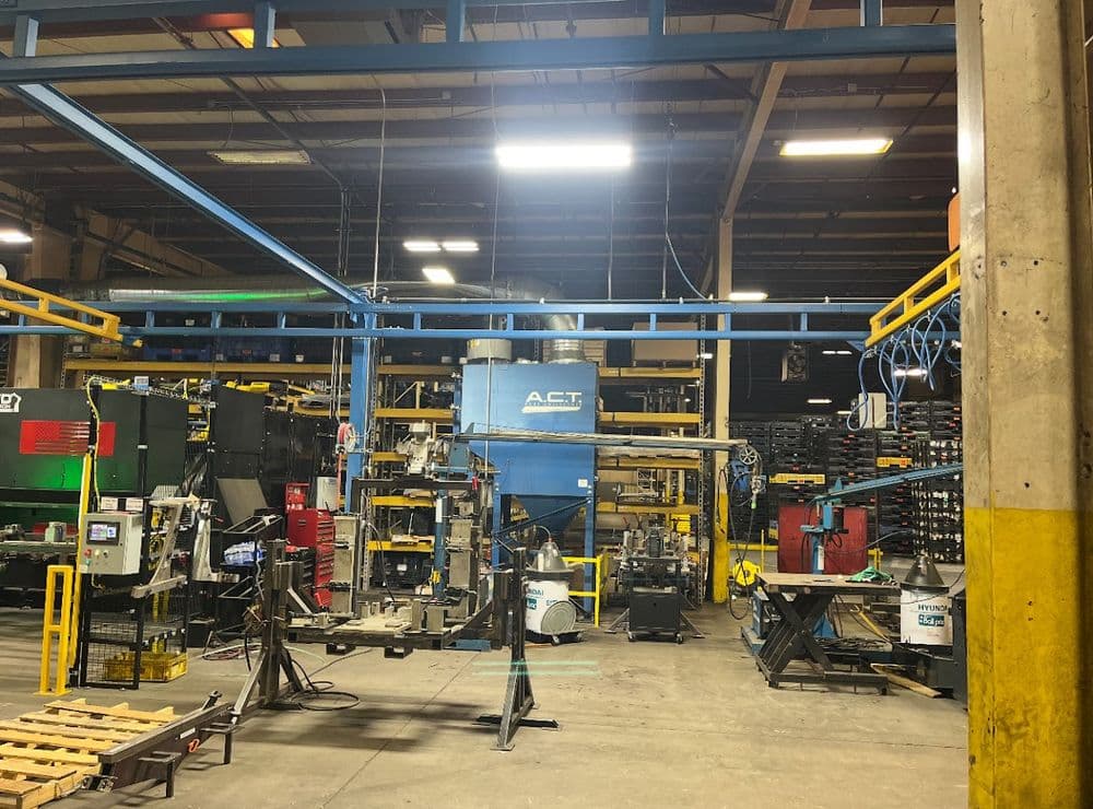 Industrial workspace featuring machinery and equipment, highlighting a busy manufacturing environment.