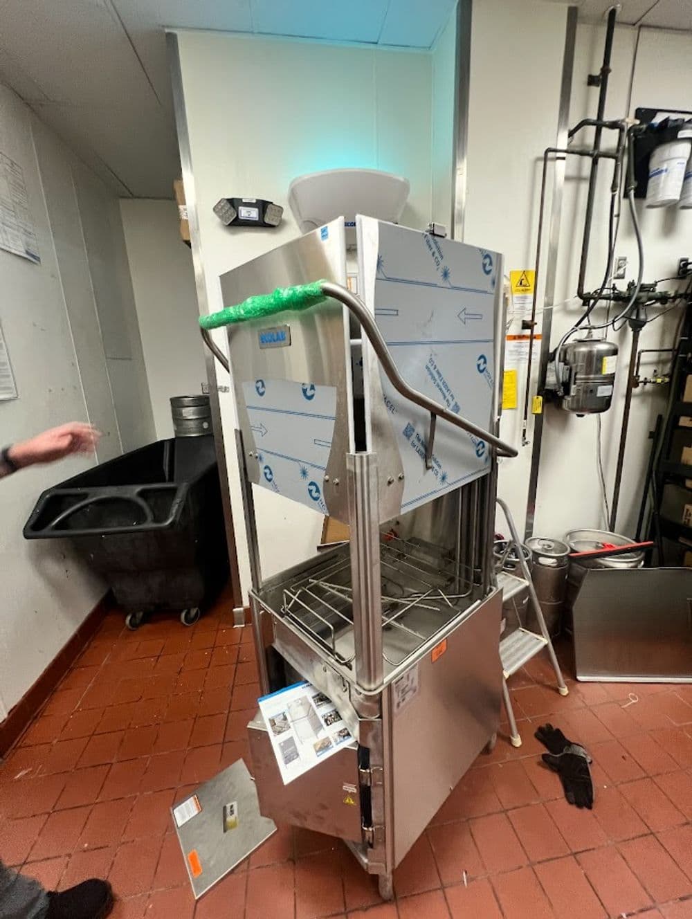 Commercial kitchen equipment with protective film in a food service environment.