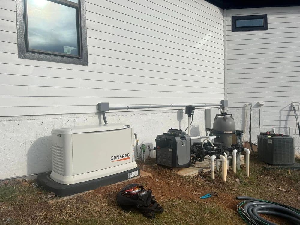 Generac generator installation next to a house, with plumbing and pool equipment visible.